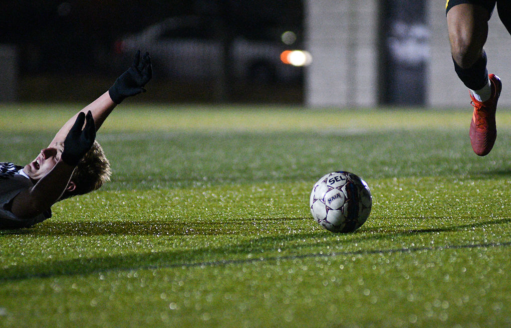 Columbia College forward Joe Spotanski falls